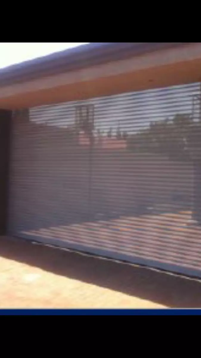 Straight-on exterior shot of a grey roller shutter garage door