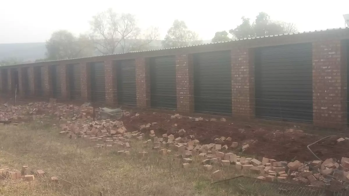 Row of brick storage units with roller doors